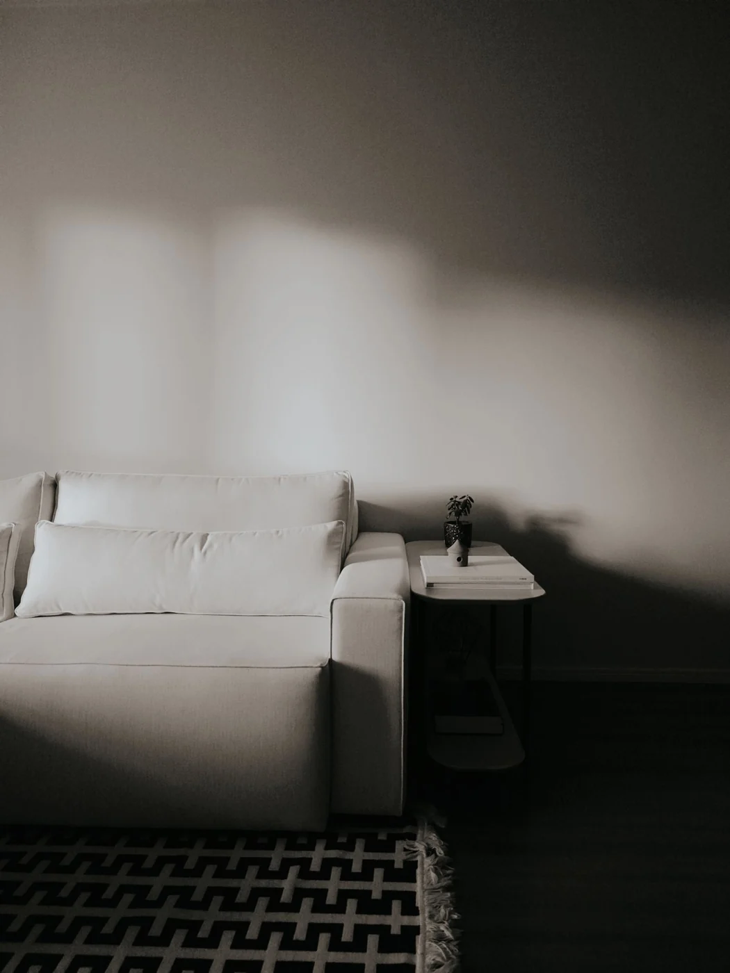 A pale sofa and low table in a living room.