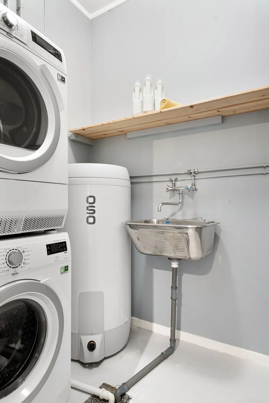 A tidy, organized laundry space with appliances and sink showcasing efficiency and design.