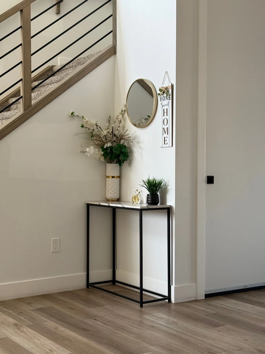 Stylish home entryway featuring a minimalist console table with decorative items.
