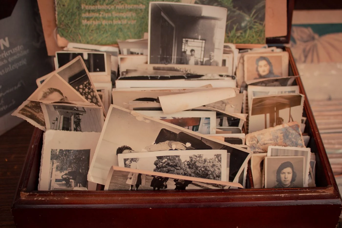 Old photographs gathered inside a wooden keepsake box.