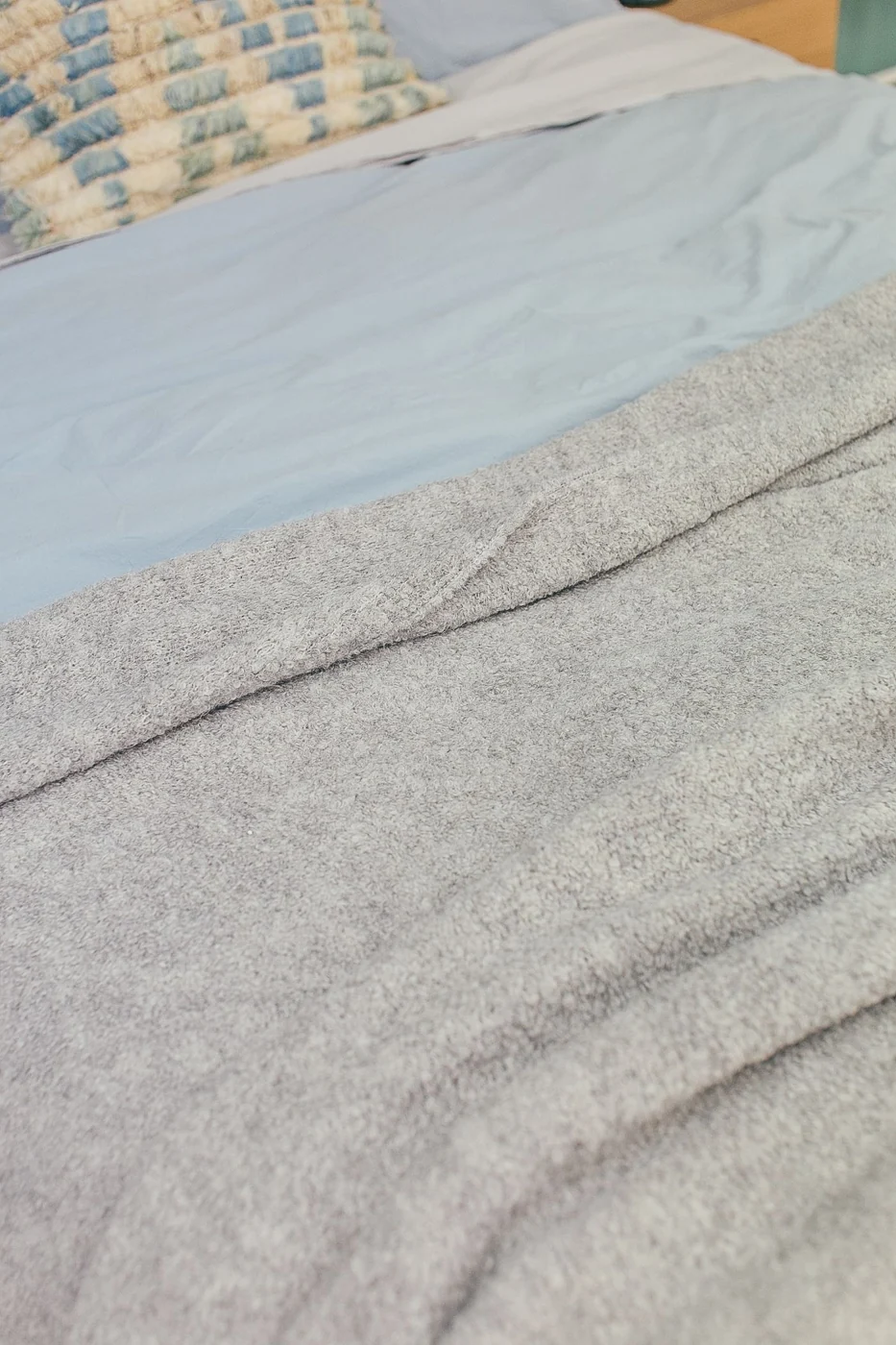 A minimalist bedroom setting featuring cozy blankets and soft textiles in a peaceful ambiance.