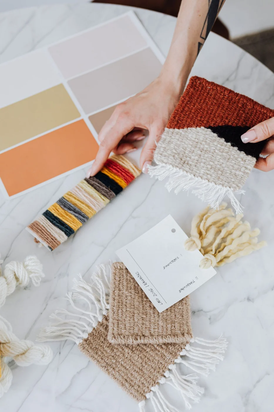 Interior designer holds textile samples for a renovation project, showcasing a modern and creative workspace.