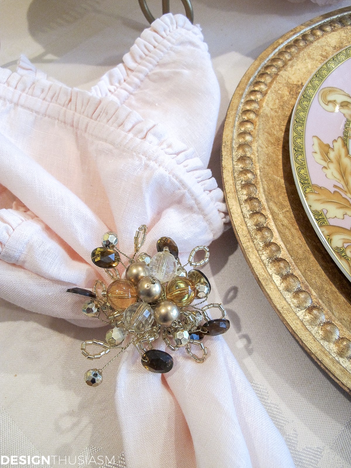 Tea party table setting with pink and gold napkins and rings