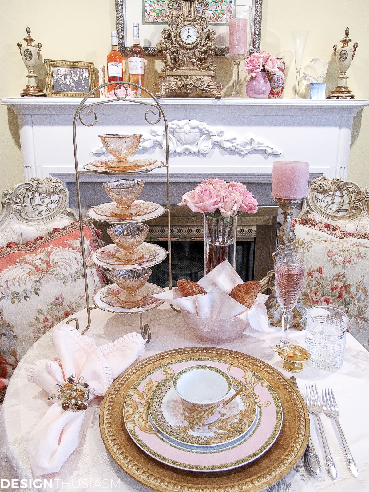 Tea party table setting with pink and gold Versace plates and aubusson pillows