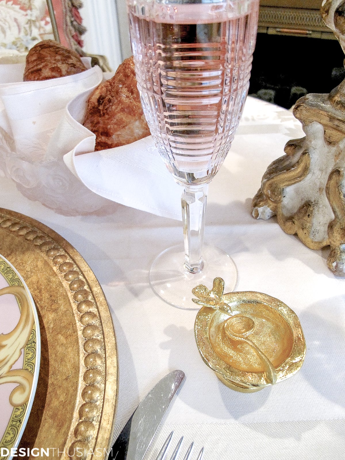 Tea party table setting with champagne flutes and gold salt cellar