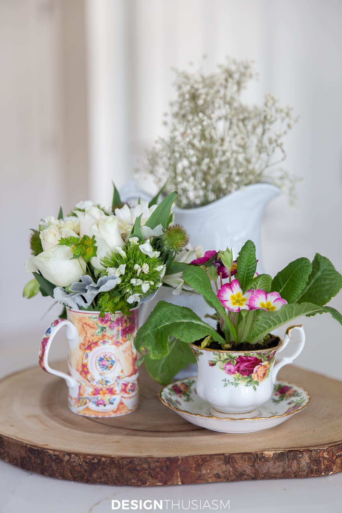 teacups displayed with potted plants and flowers