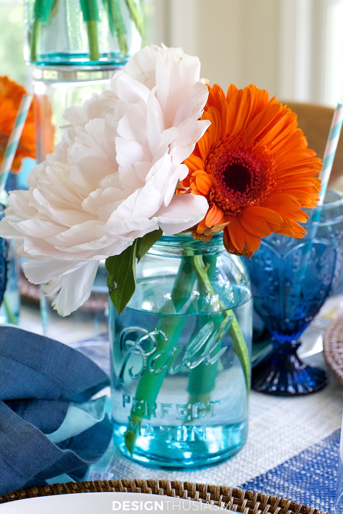 summer clambake table with flowers in mason jars
