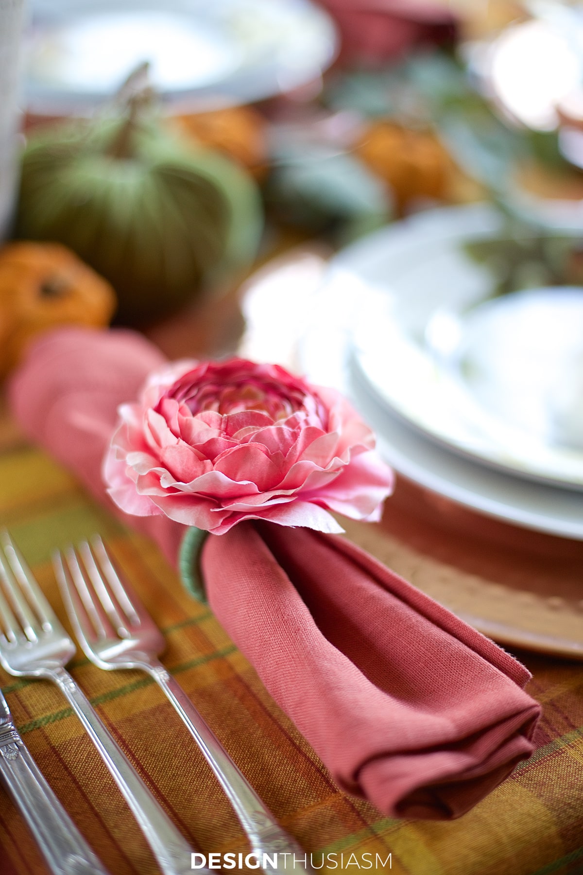 rust napkins with pink flower napkin rings in a fall tablescape