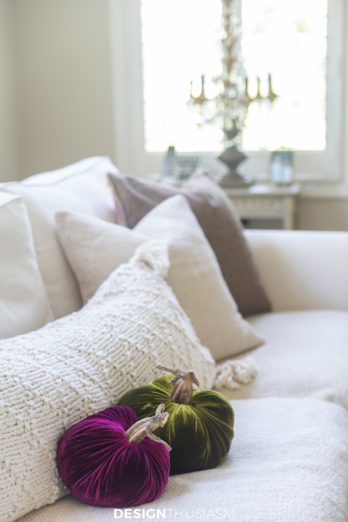family room sofa with pillows and velvet pumpkins