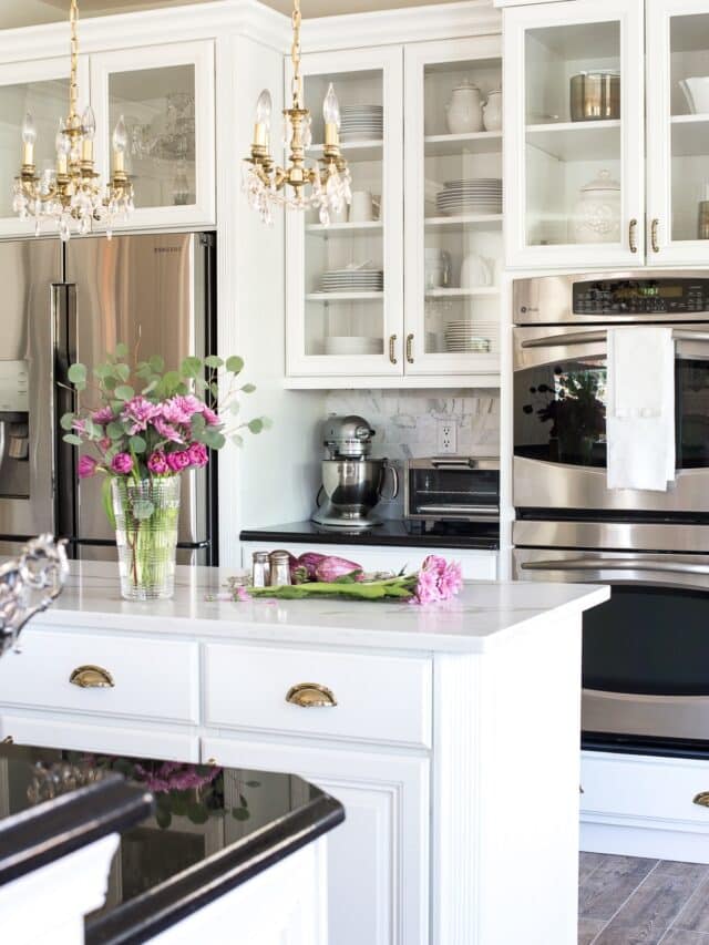 white kitchen with painted glass front cabinets