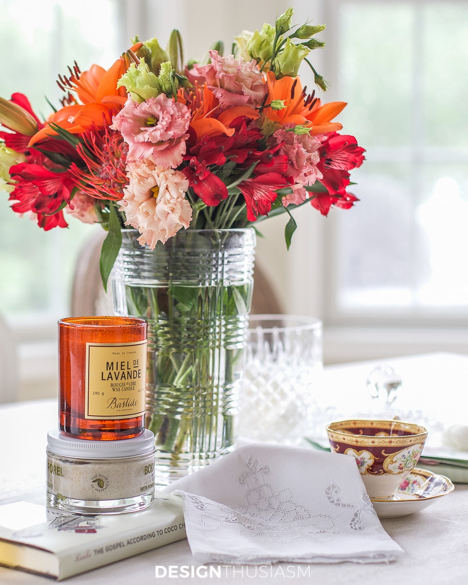 olive oil scrub, candle, teacup and flowers