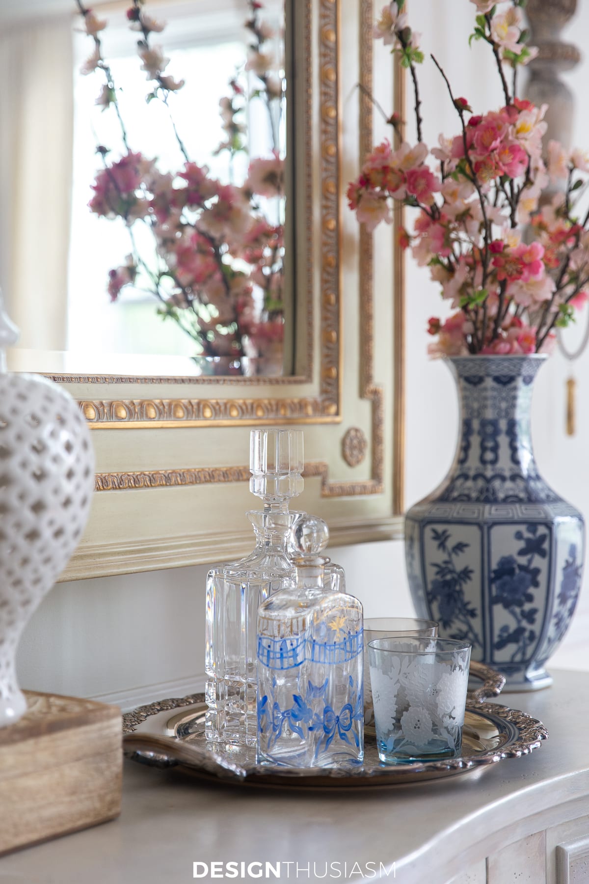 sideboard with cherry blossoms and decanters on a tray