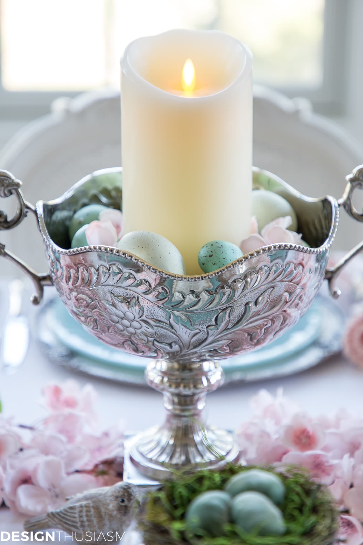 Easter centerpiece in a spring tablescape with eggs and cherry blossoms