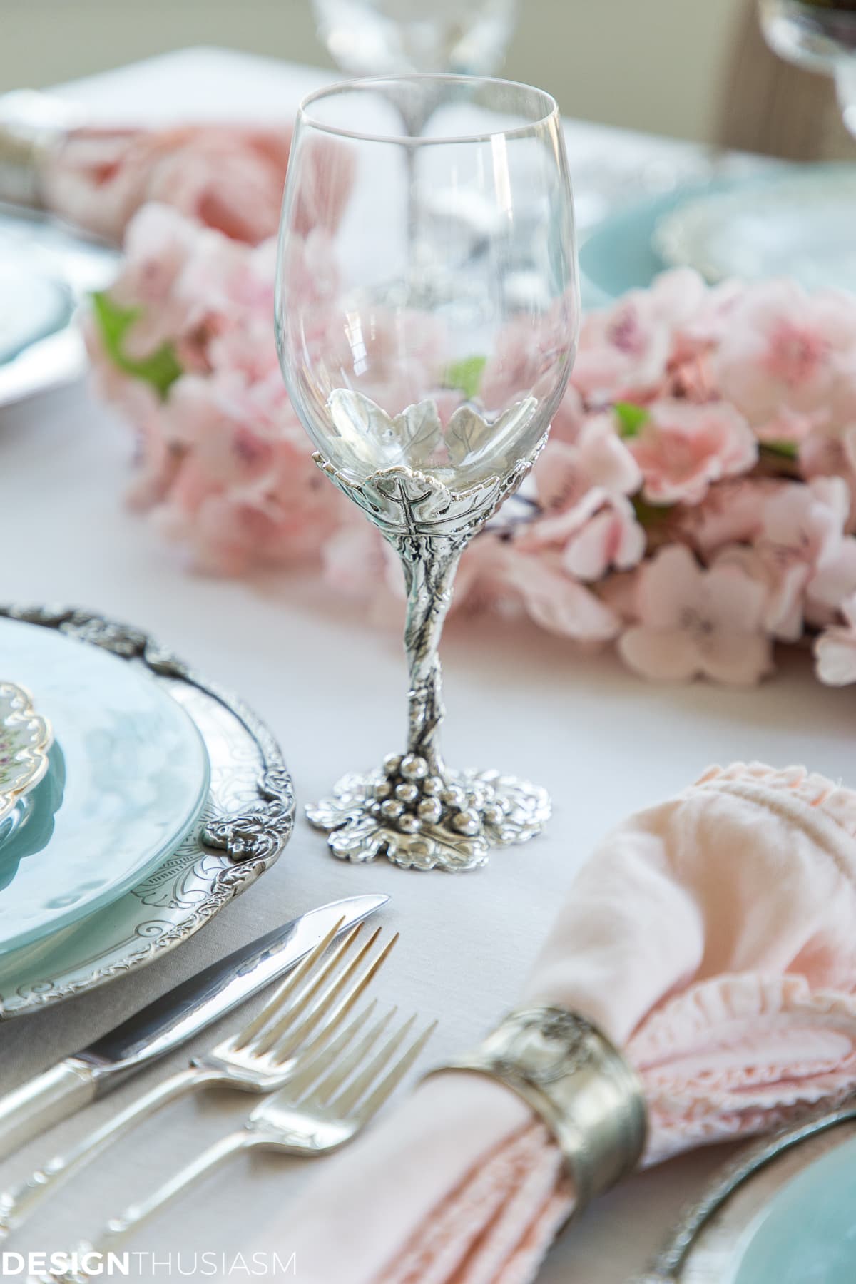 silver wine goblet in a cherry blossom branch tablescape