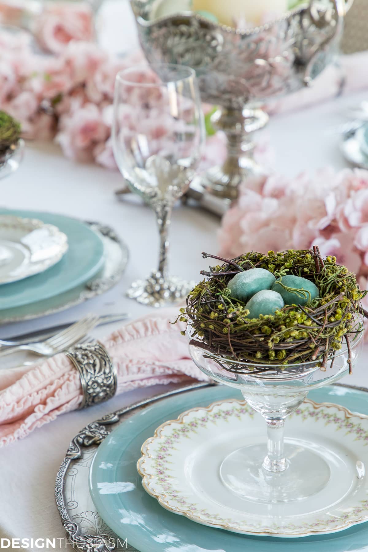 Easter table setting with nests and cherry blossom branches