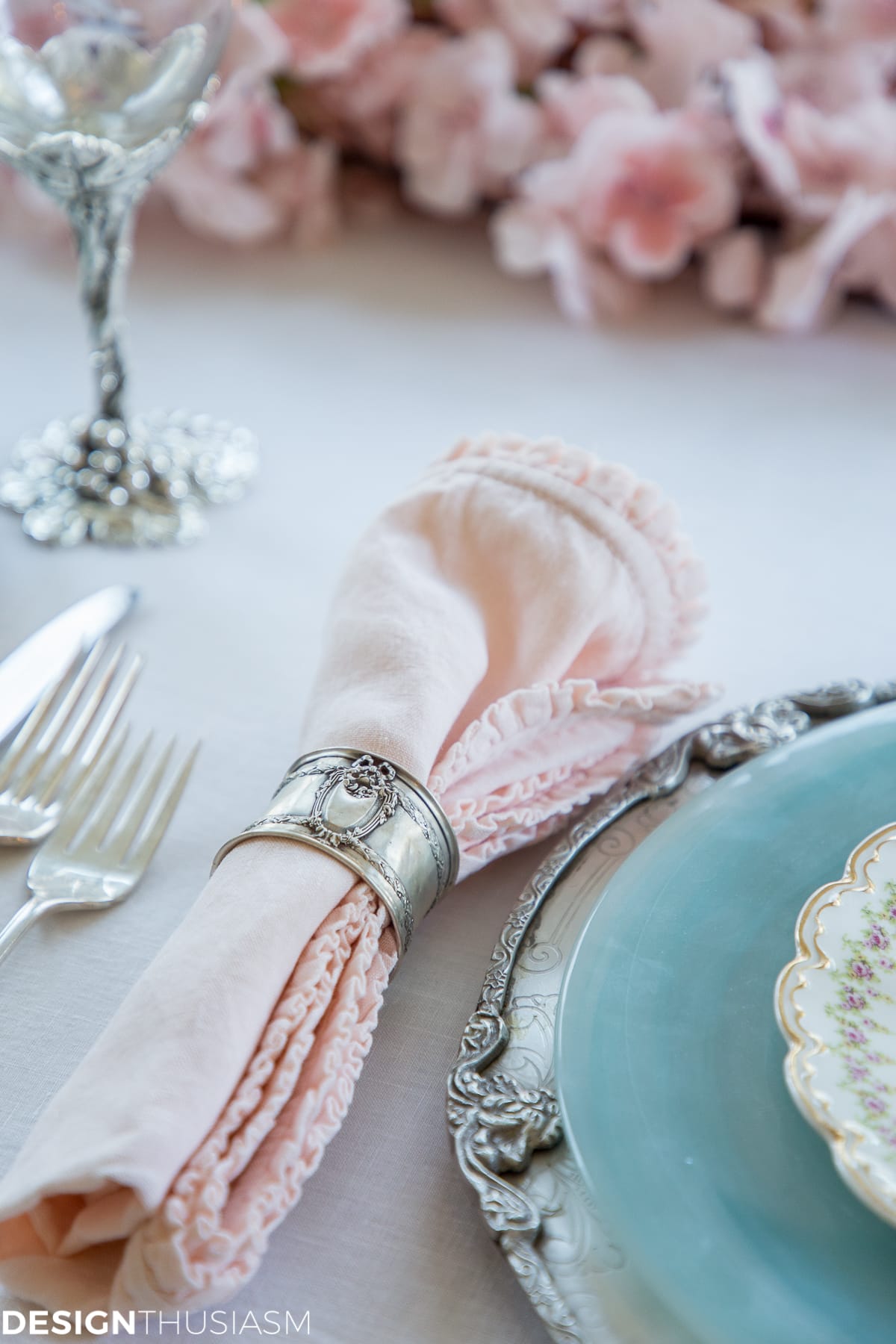 blush pink ruffled napkin and silver napkin ring 