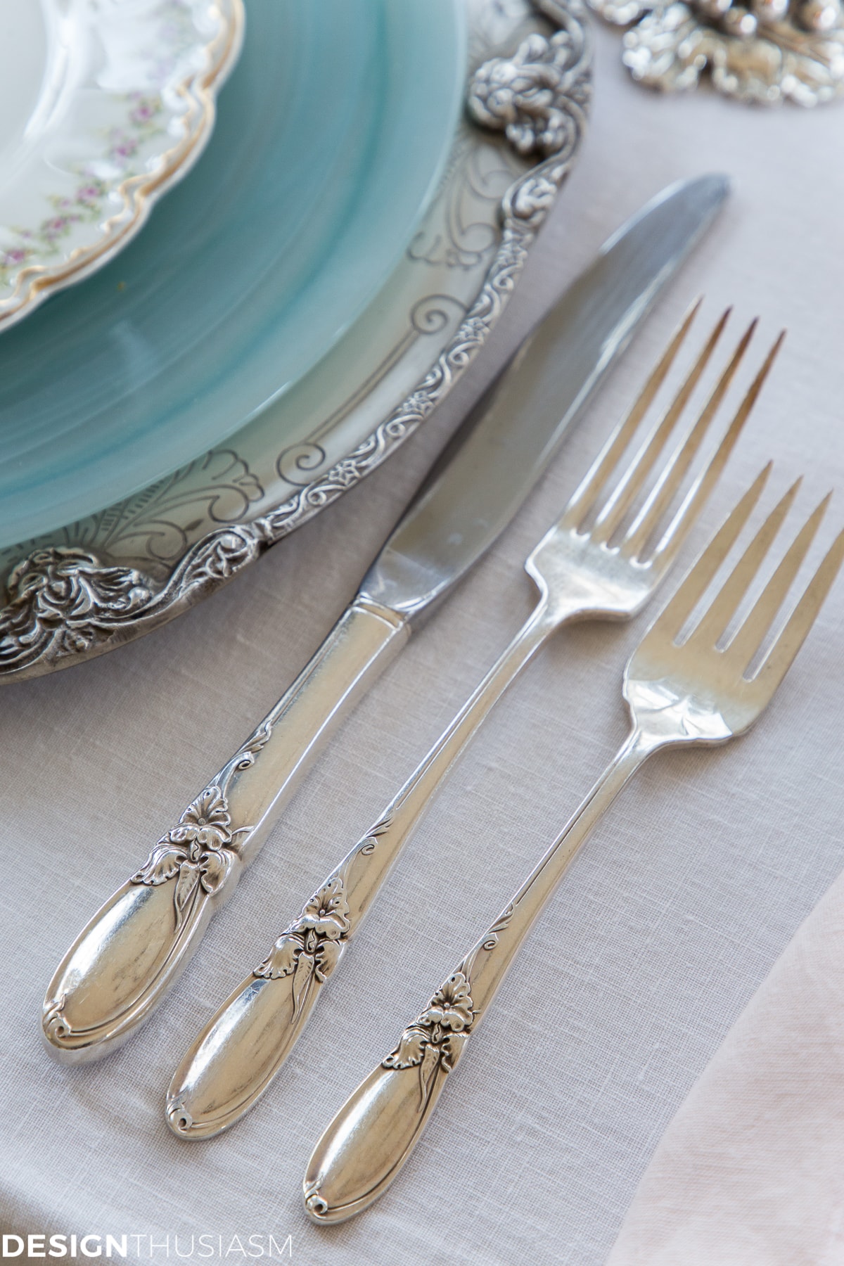 vintage silverware in a cherry blossom branch tablescape