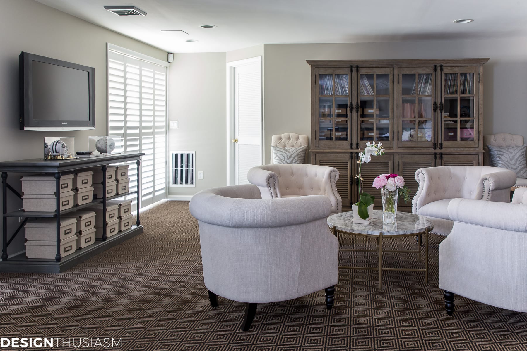 basement finishing conversation area with plantation shutters on sliding doors