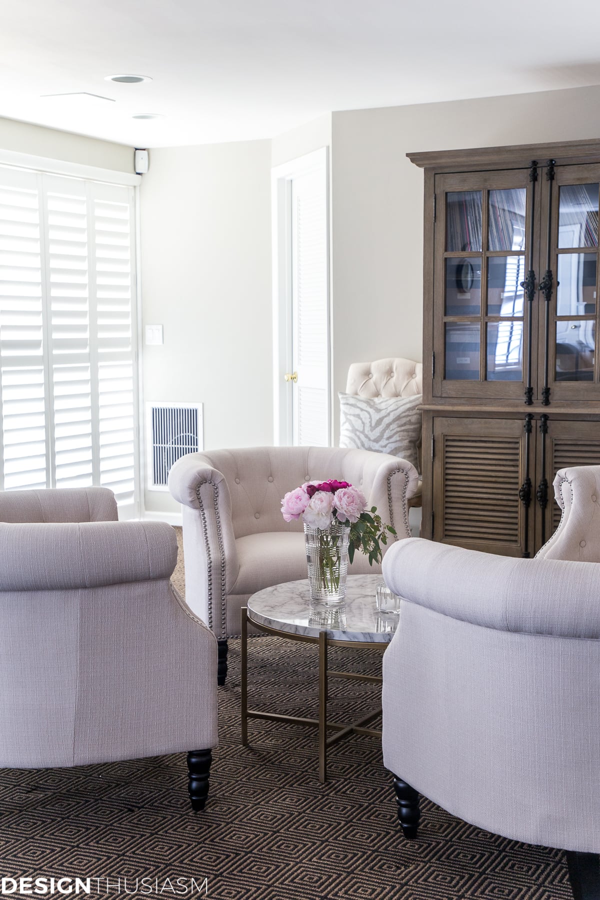 basement finishing white chairs and plantation shutters on sliding doors
