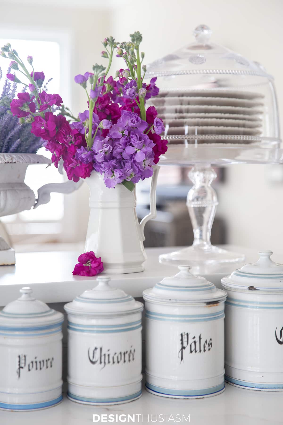 organized kitchen counters with canisters and cake plate
