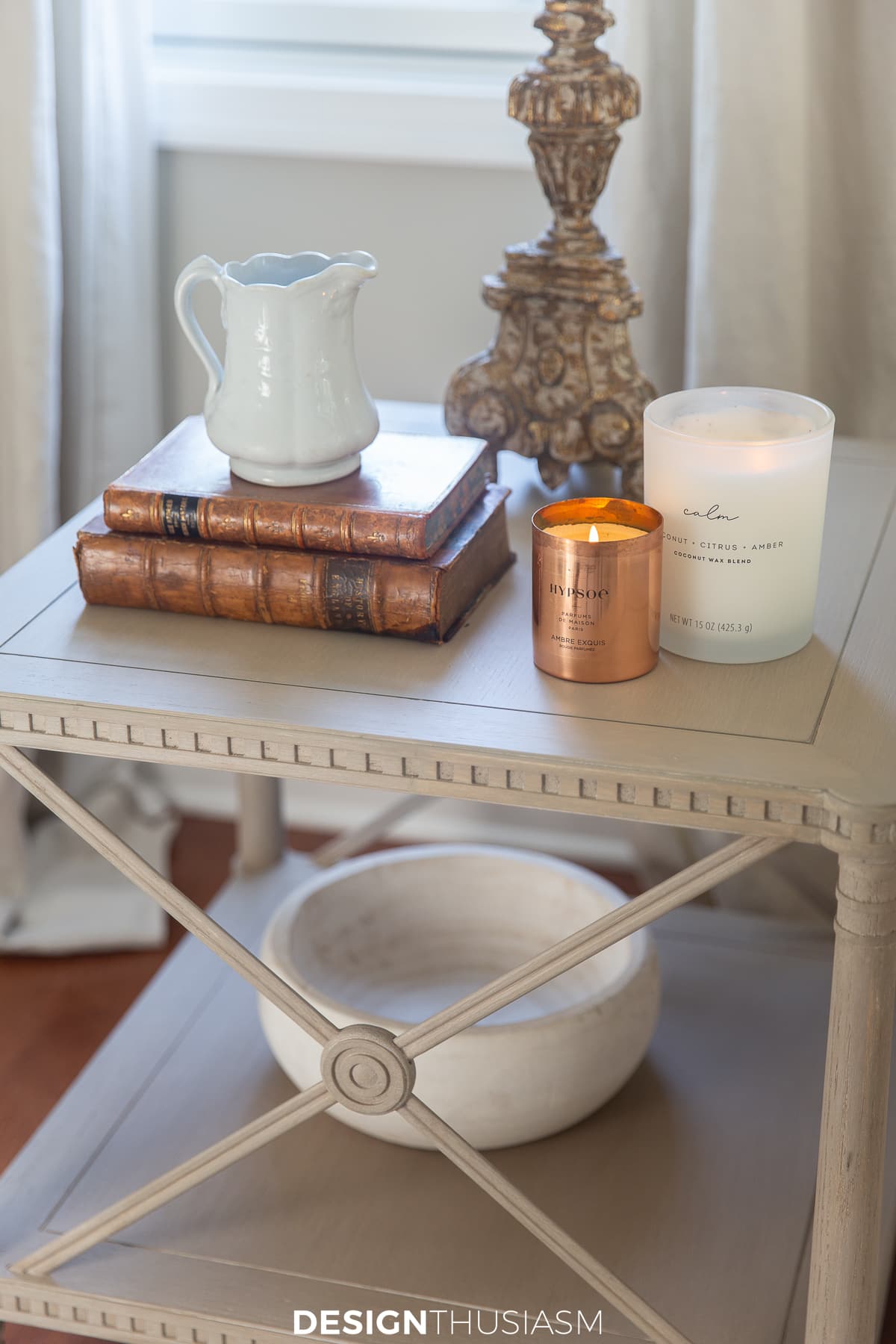side table with leather books and copper candle