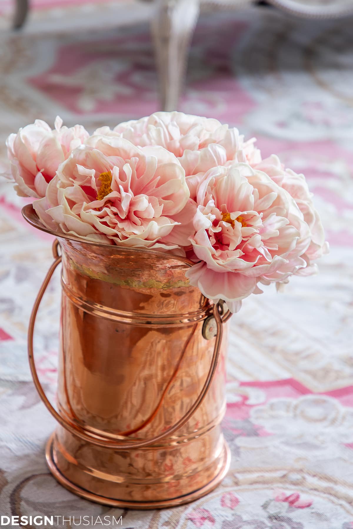 living room decor with faux peonies in a copper vase