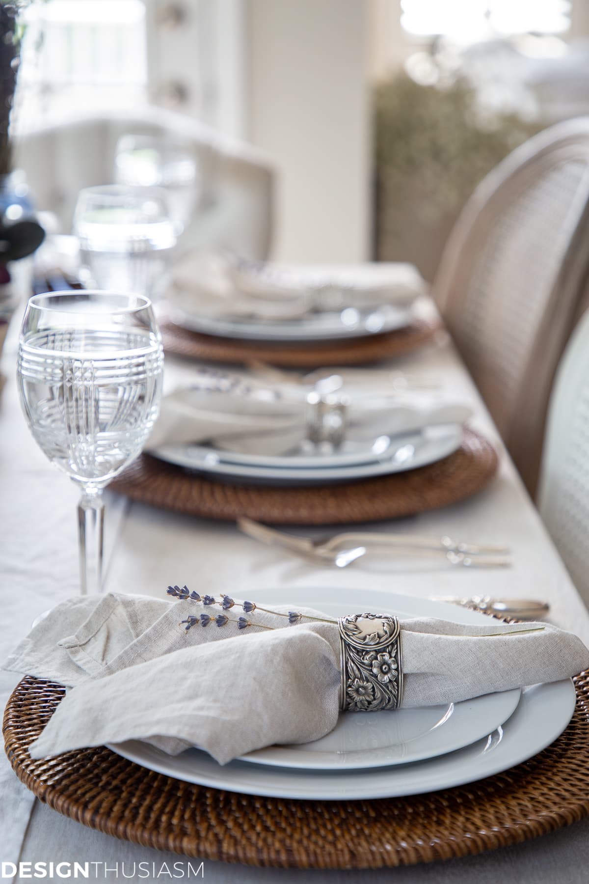 summer tablescape with linen napkins, chair covers and lavender sprigs