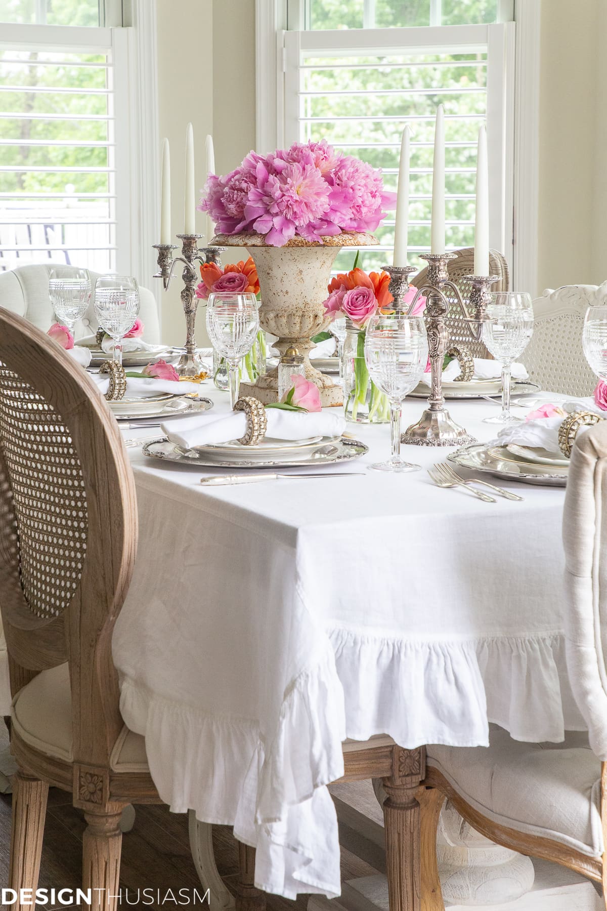 white dining table setting with a ruffle tablecloth