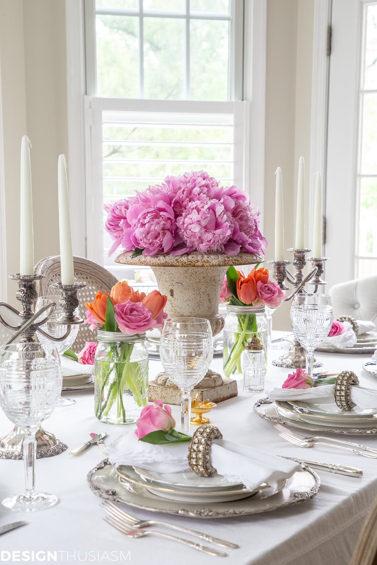 white dining table setting with summer color florals