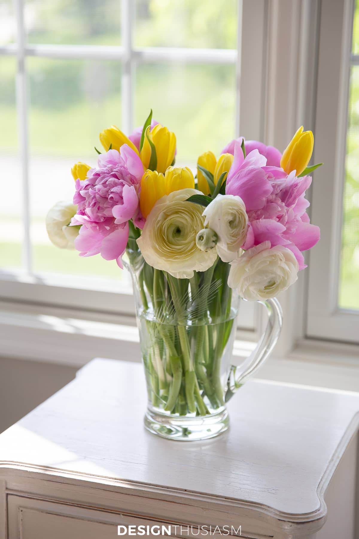 flower arrangement in crystal pitcher