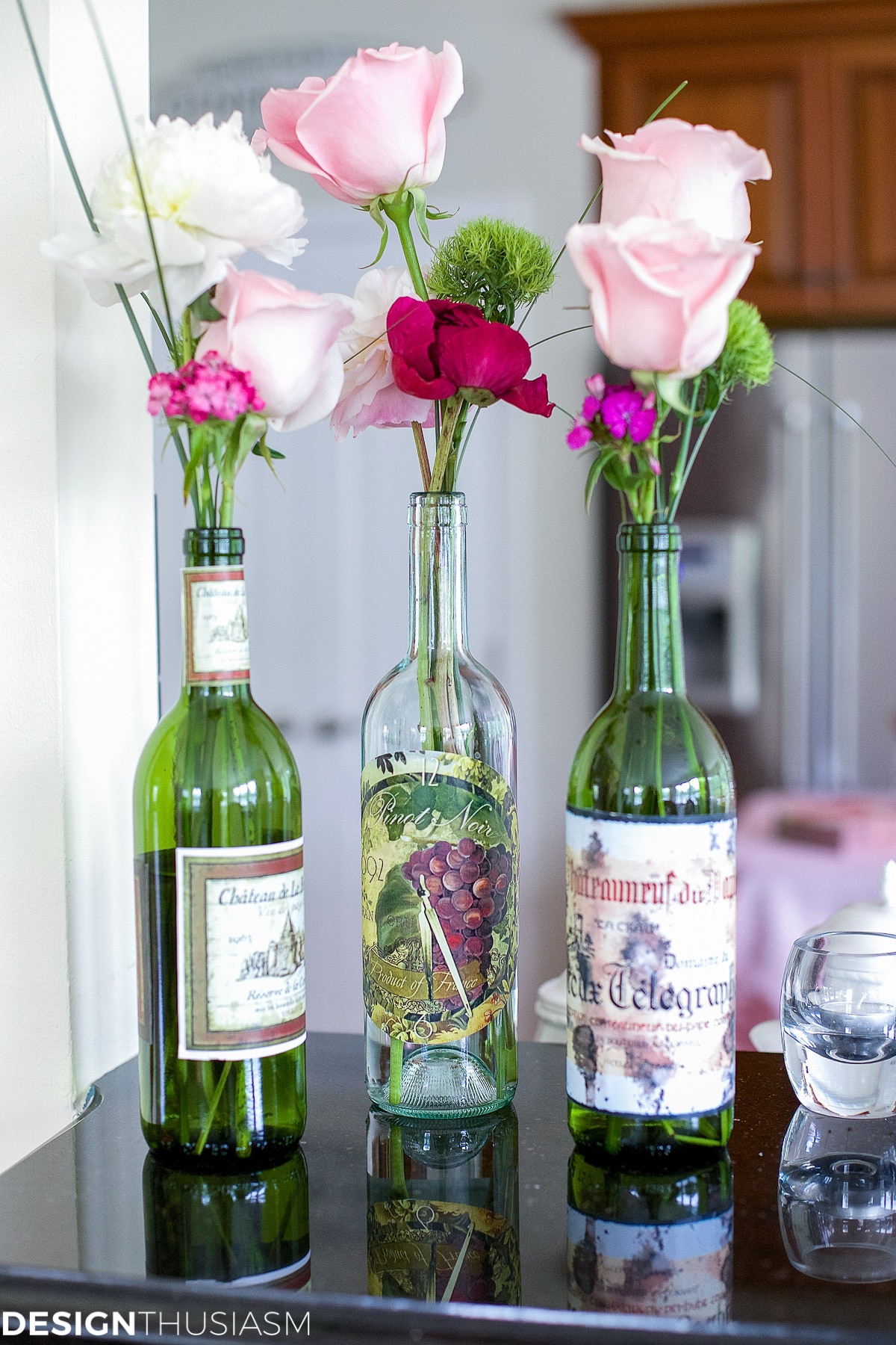 flower arrangement in wine bottles