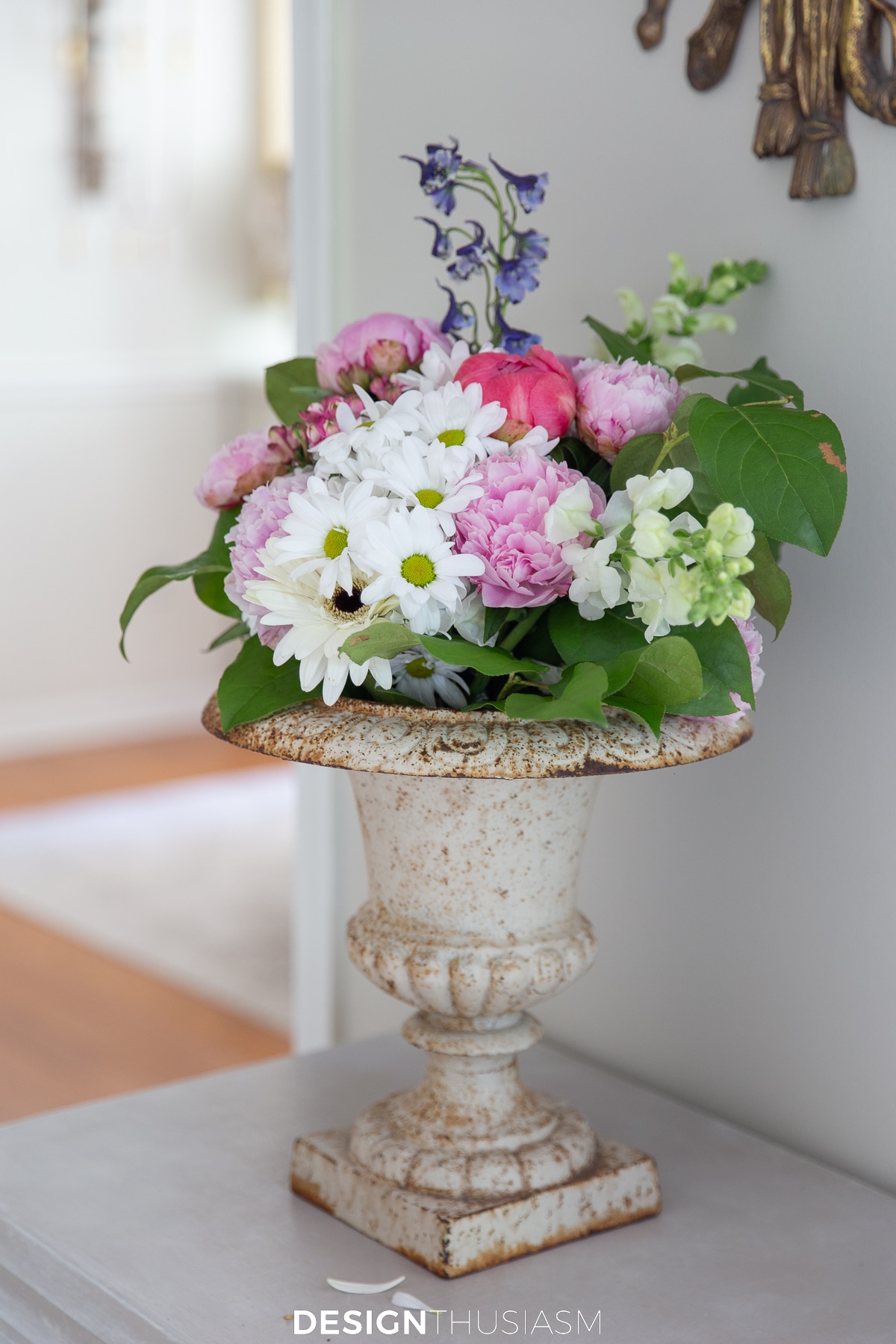 flower arrangement in cast iron garden urn