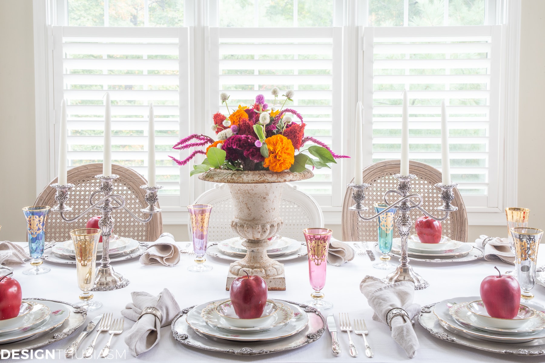 fall table setting with apples and colorful flowers
