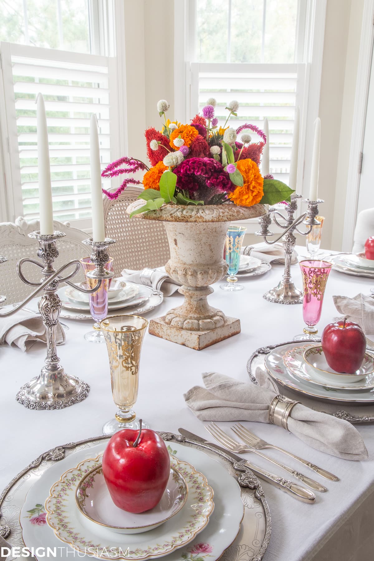 fall table setting with apple decor and colorful glasses