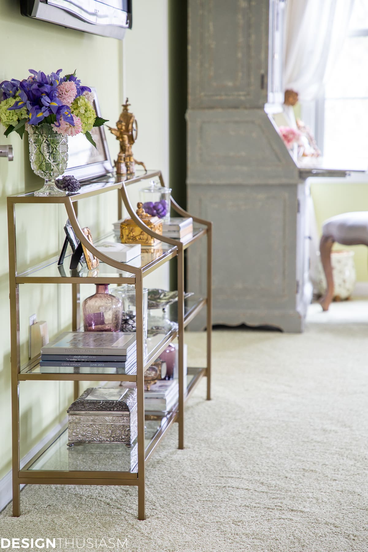 metal and glass shelving on the TV wall
