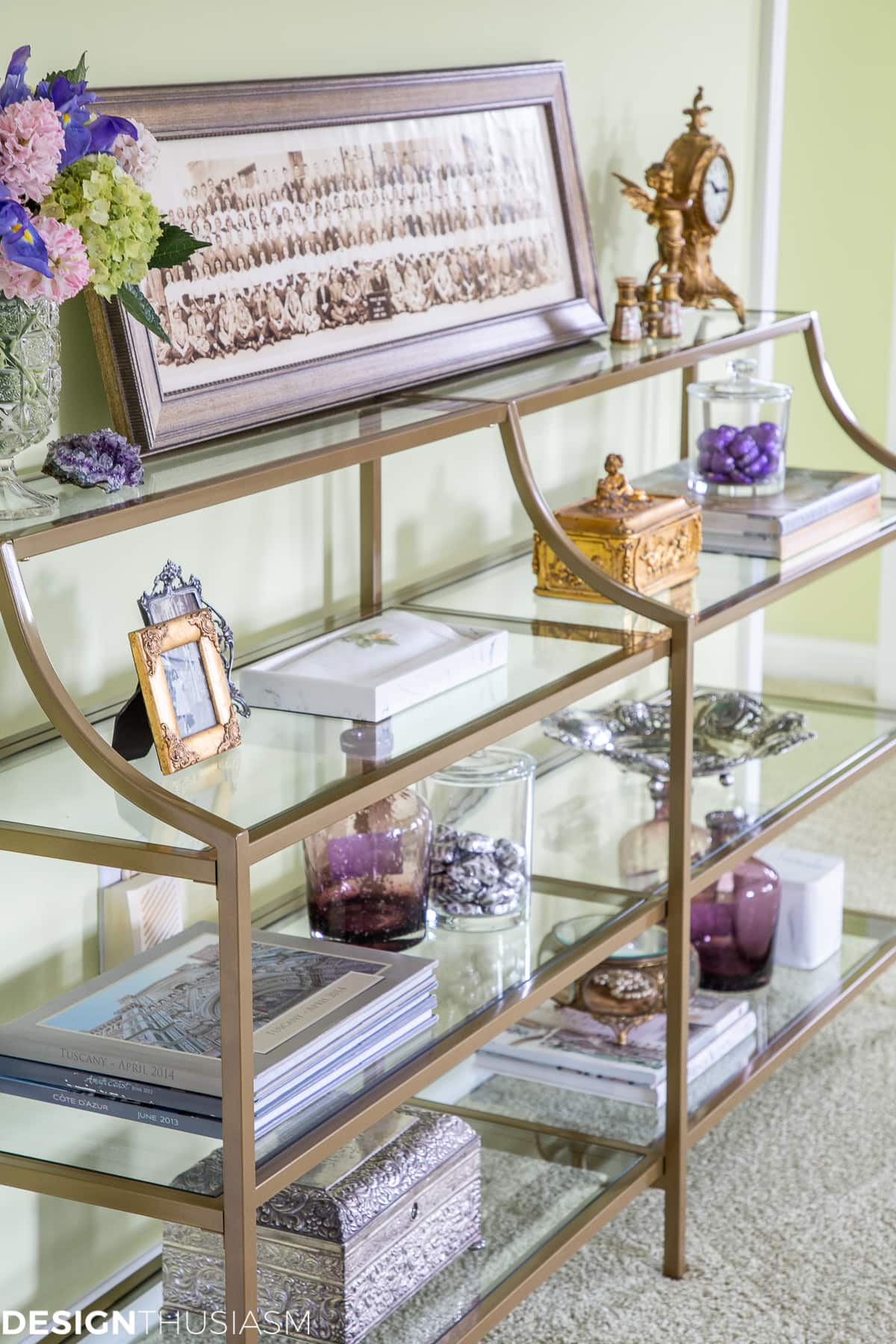 decorated shelves on metal and glass console