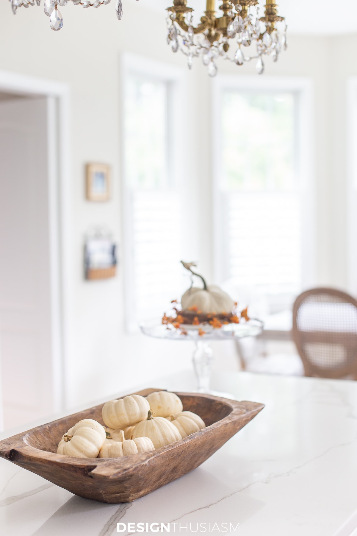 white mini pumpkins in a dough bowl