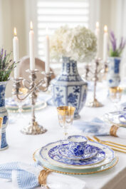blue and white china table setting with white hydrangeas