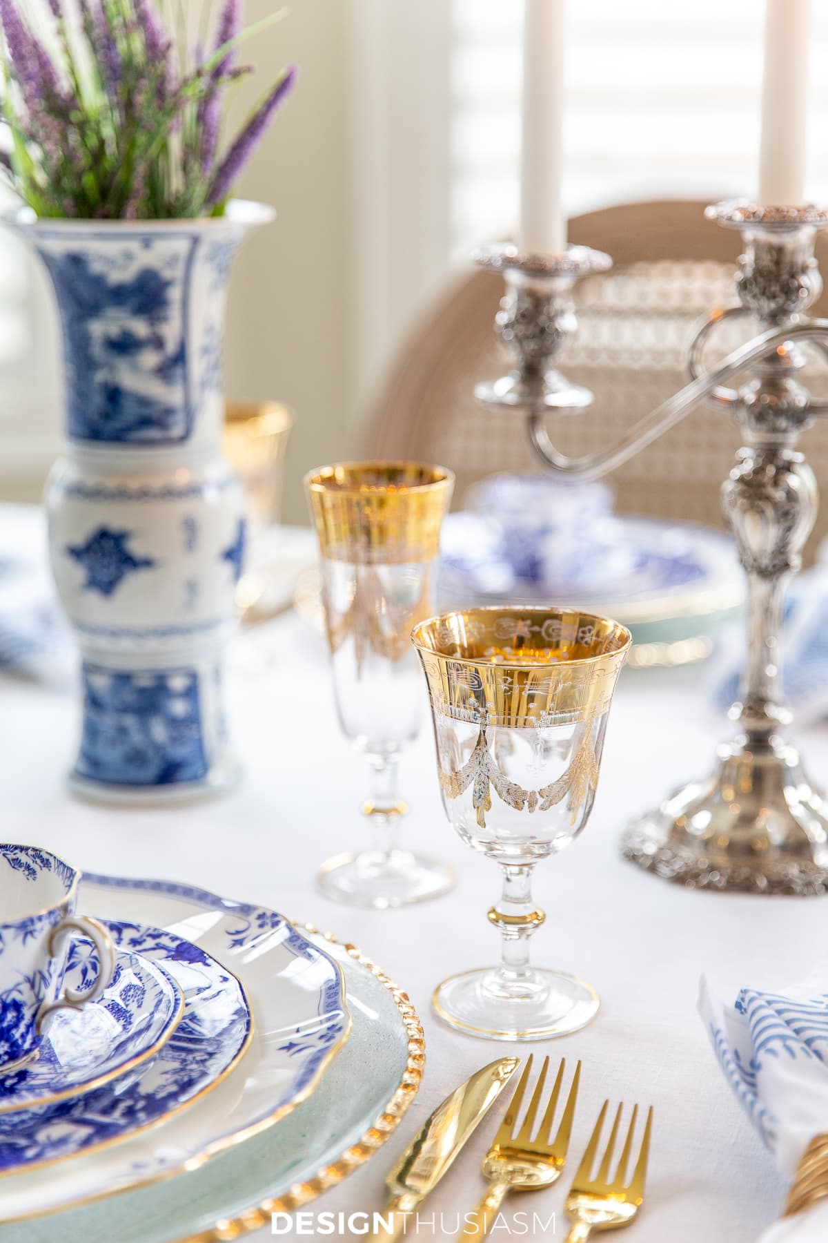 blue and white china table setting with gold rimmed goblets