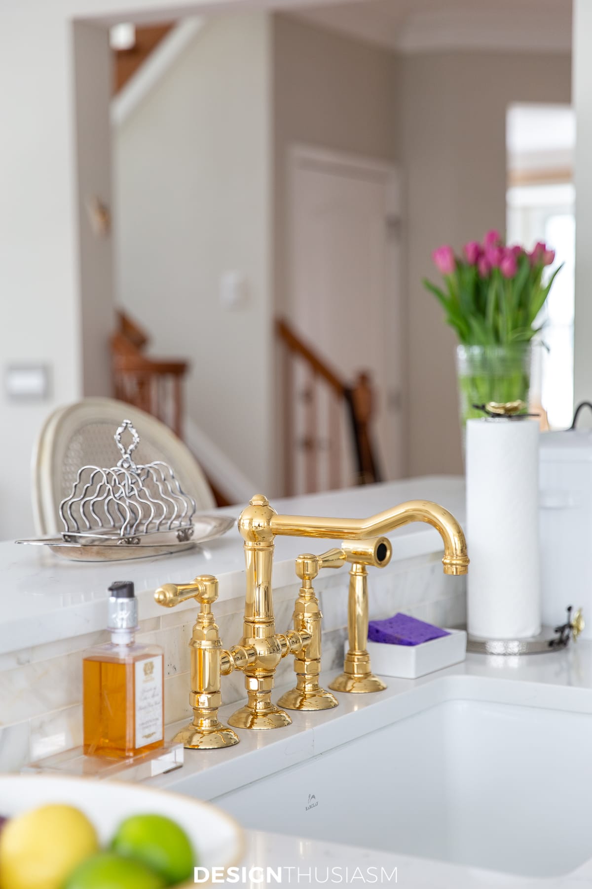 white kitchen with brass faucet