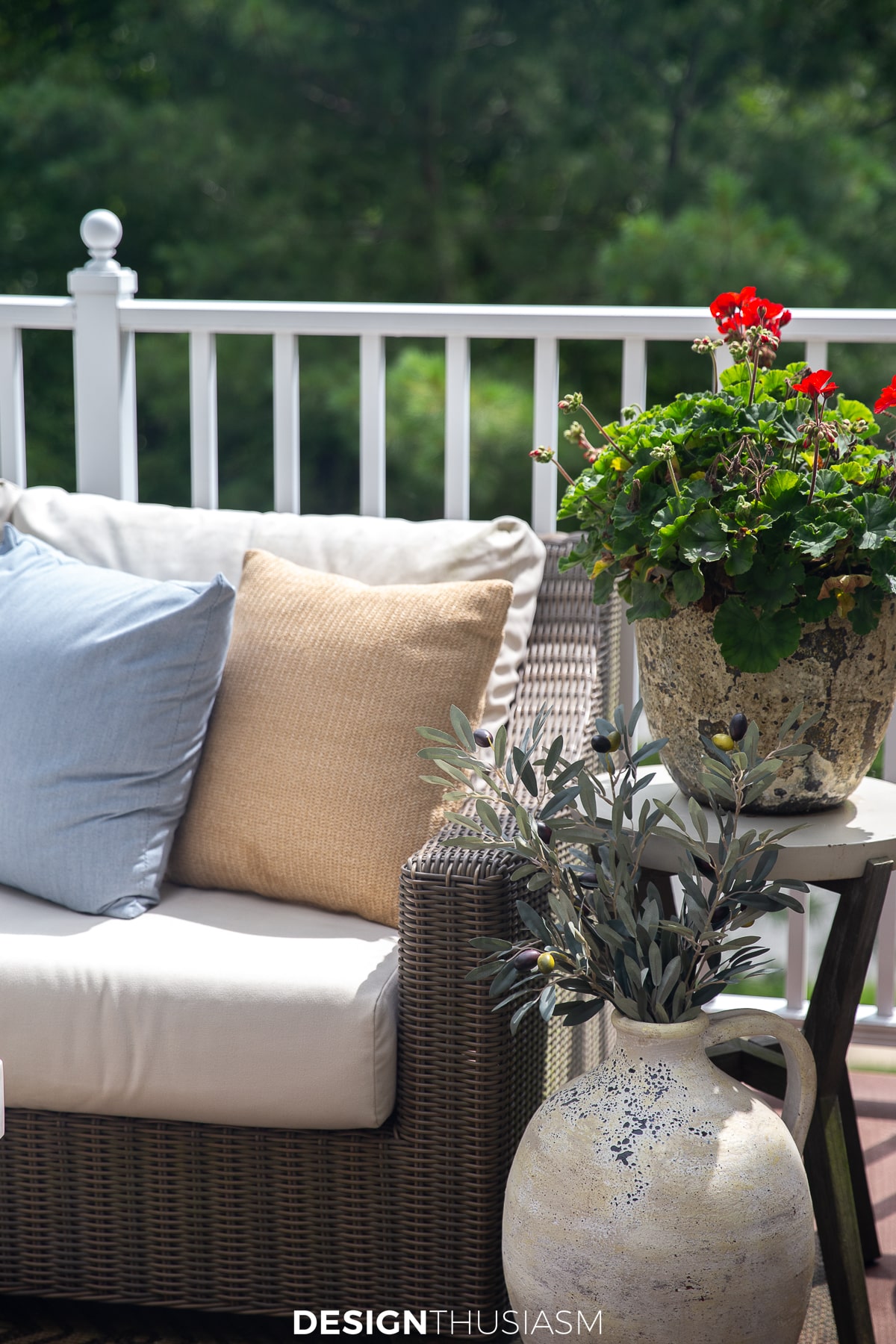 patio throw pillows and geraniums in a planter