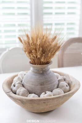 wheatstalks in vintage wood vase, vintage wood bowl filled with white craft pumpkins
