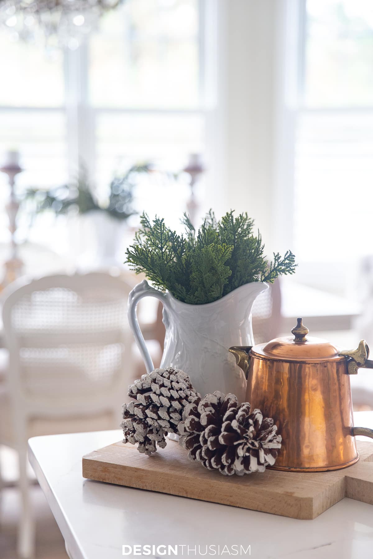Christmas kitchen with copper pot, pine cones and greenery in pitcher