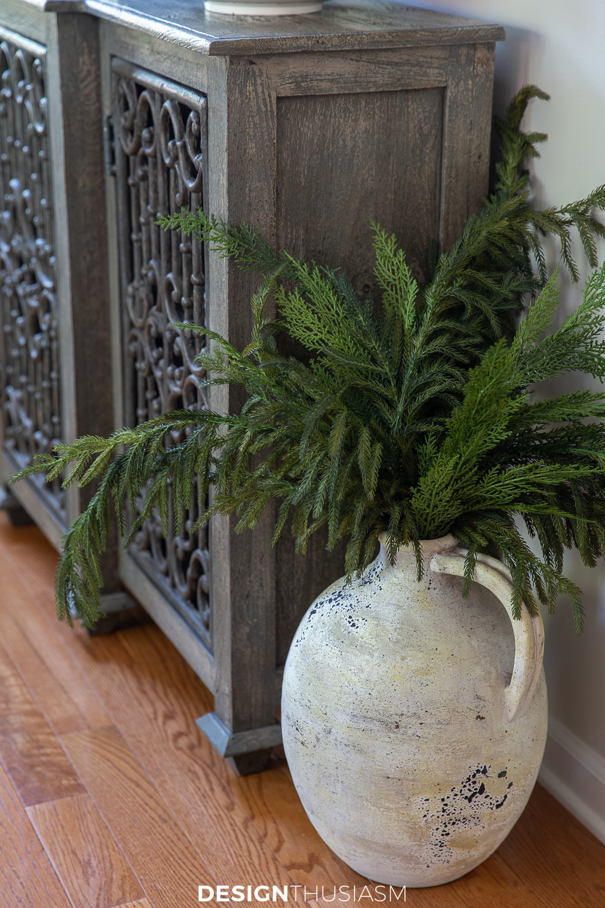 holiday family room with greenery in a floor vase