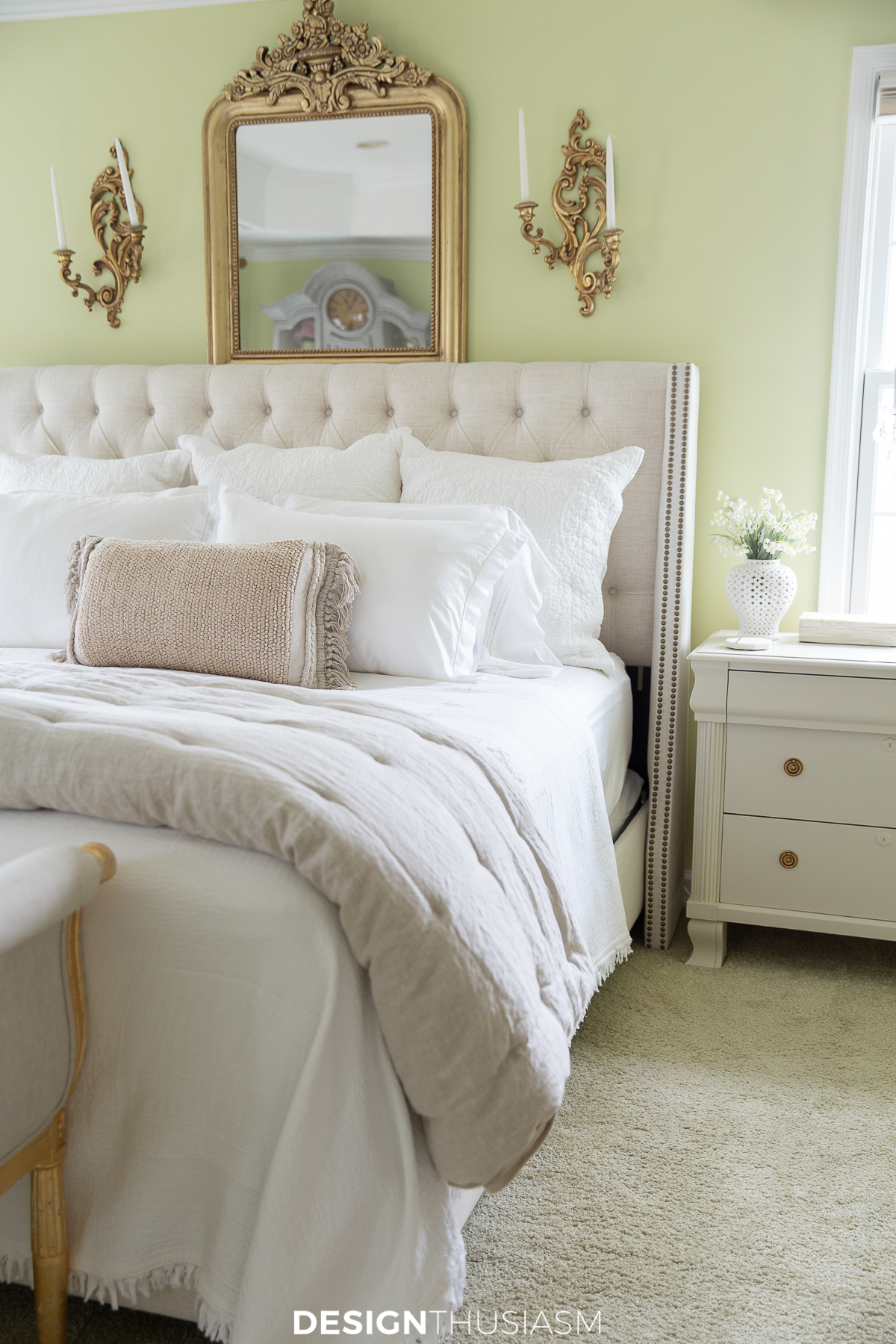 updated primary bedroom with painted nightstand