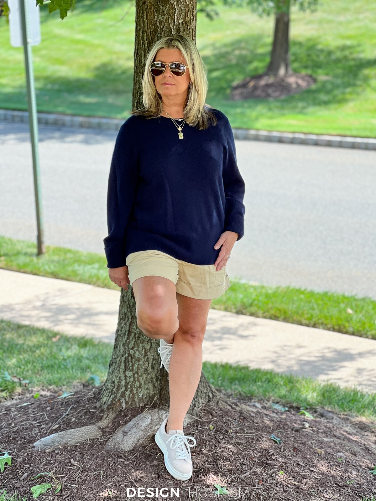 navy sweater with cuffed khaki shorts