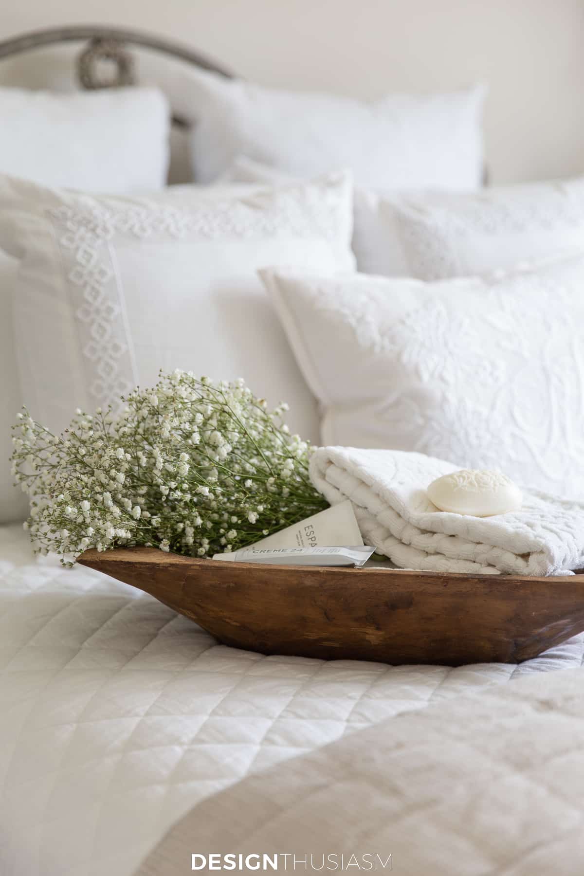 guest room bed with towels and soap