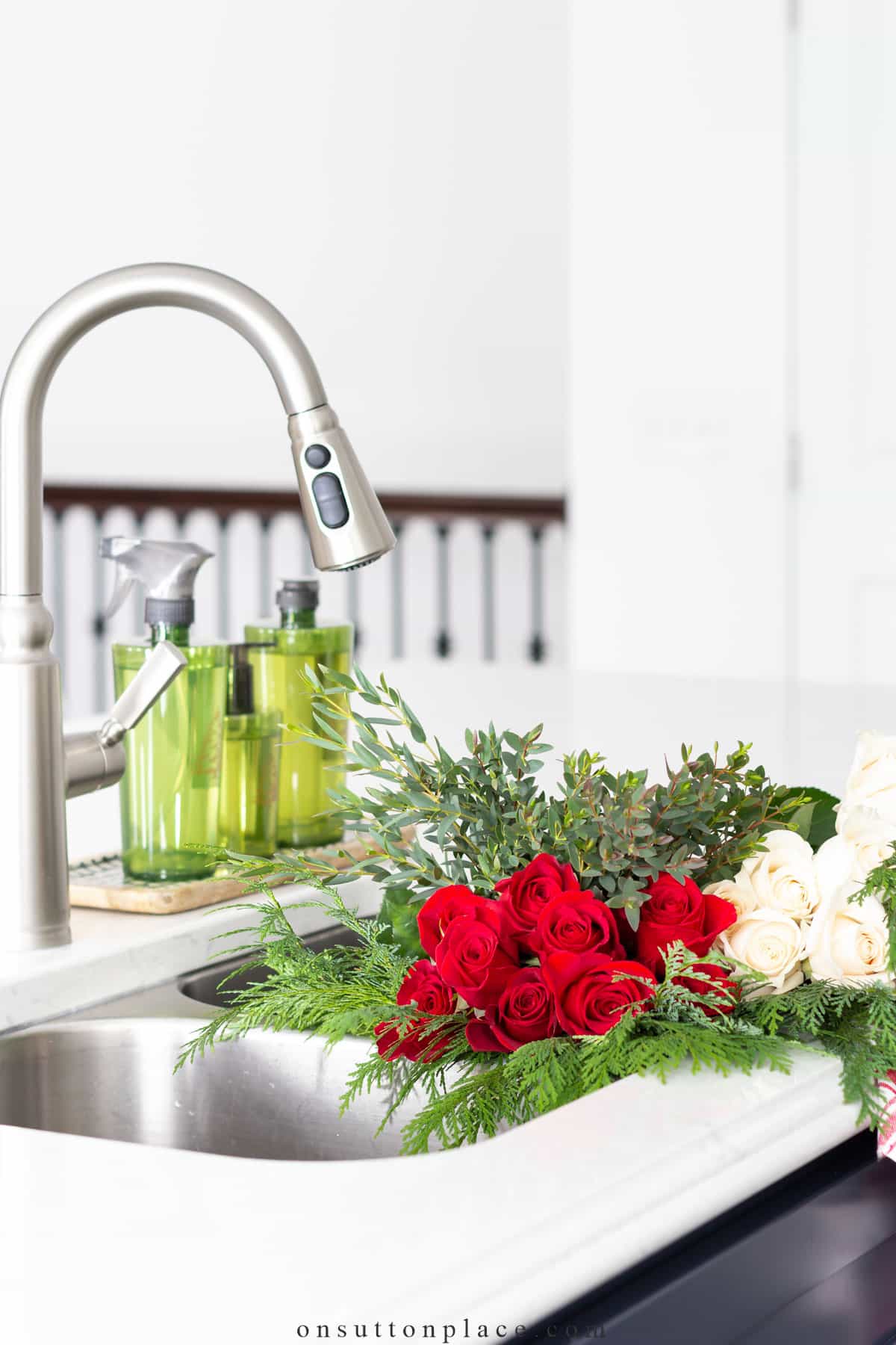 christmas flowers and greenery in kitchen sink