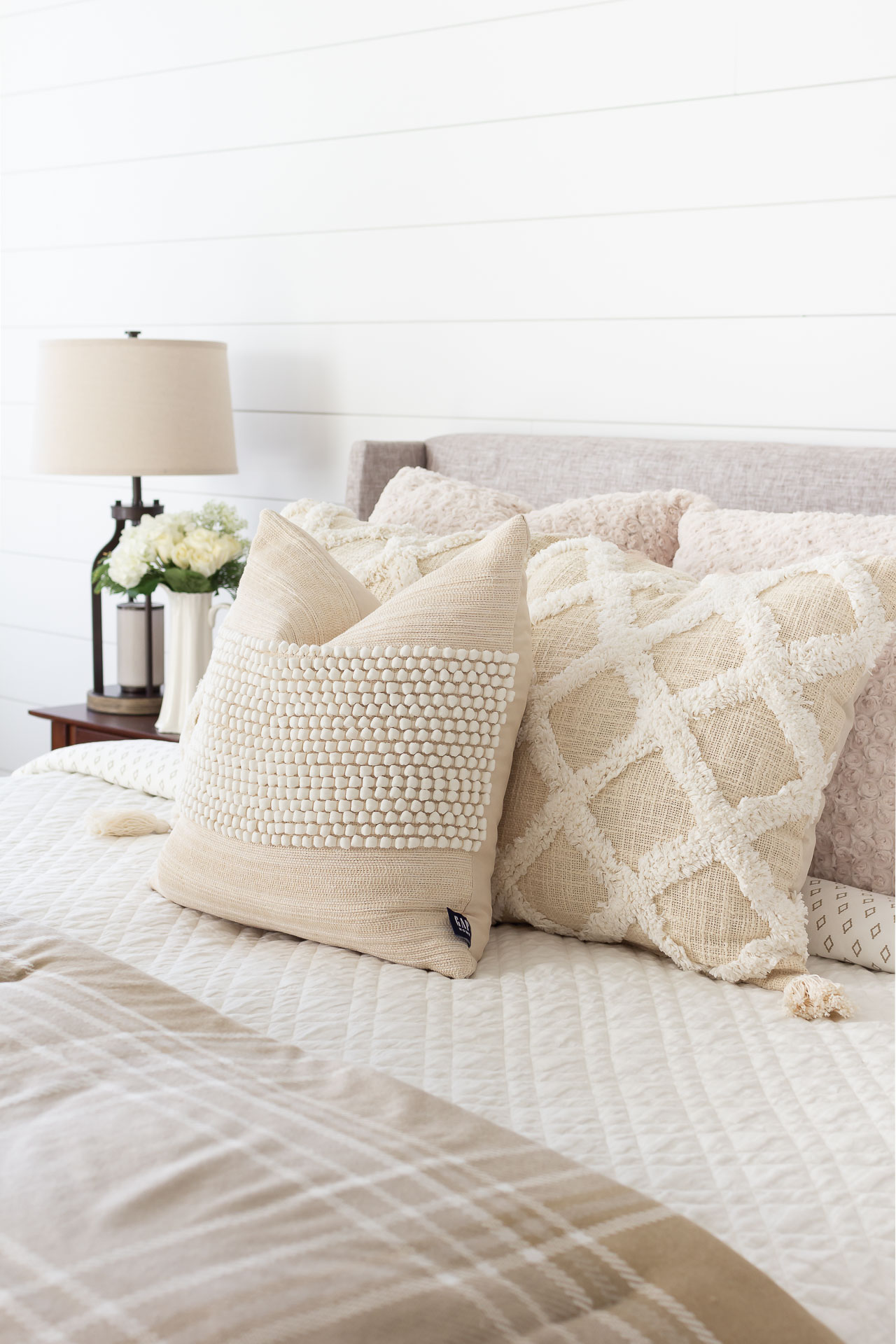 neutral pillows on bed