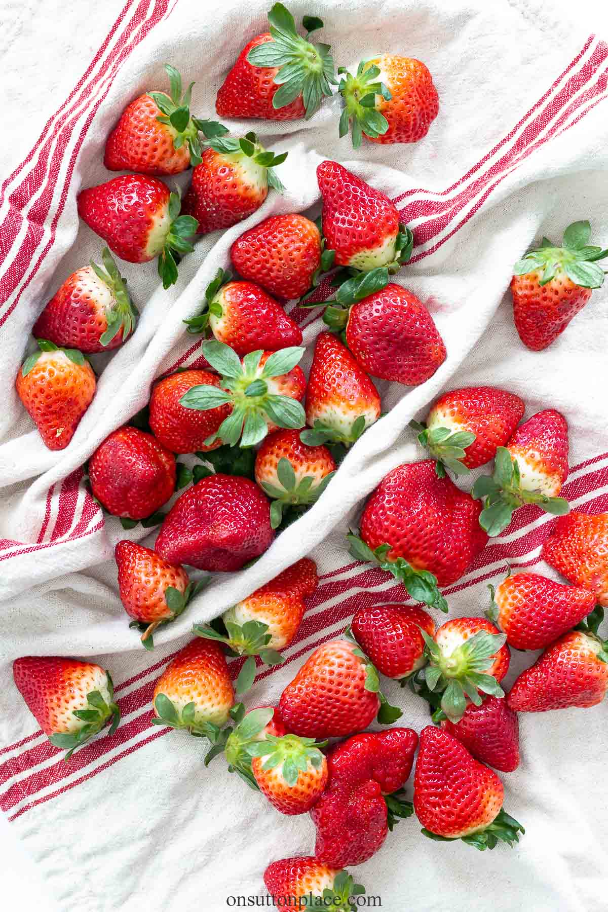 fresh strawberries on red striped towel